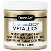 DecoArt Americana Decor Metallics Champagne Gold paint bottle against a plain background
