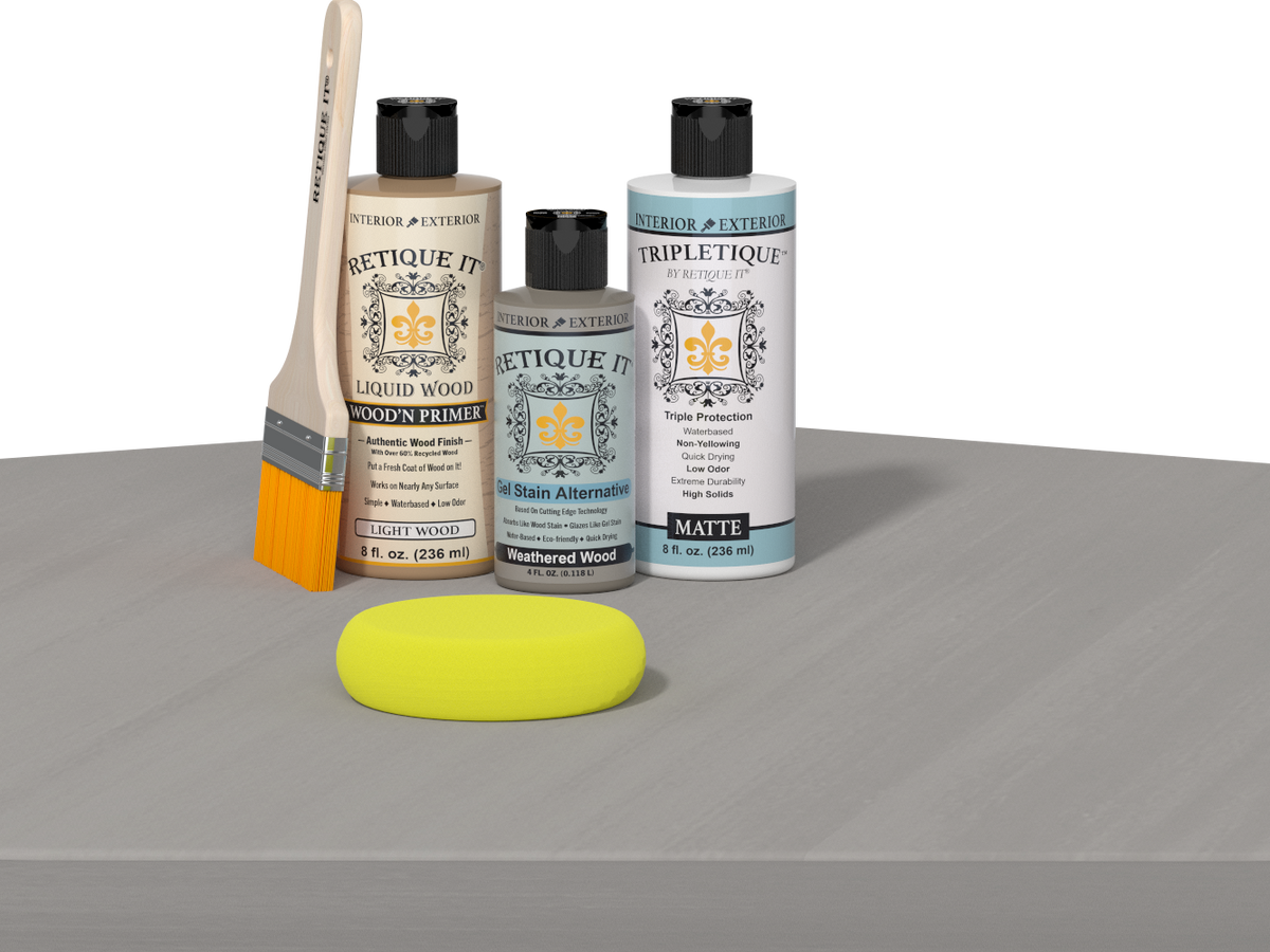 Retique It® Weathered Wood Multipurpose Kit contents with Light Wood Liquid Wood primer, Weathered Wood gel stain alternative, Tripletique matte interior top coat, paintbrush, and yellow sponge displayed on a wood surface.