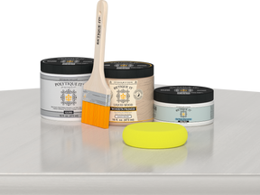 Retique It® White Wash Multipurpose Kit contents with Liquid Wood primer, White Wash gel stain alternative, PolyTique It® gloss exterior top coat, paintbrush, and yellow sponge displayed on a white wood surface.