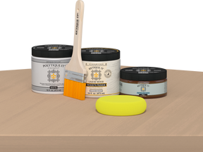 Retique It® Pecan Multipurpose Kit contents with Bleached Wood Liquid Wood primer, Pecan gel stain alternative, PolyTique It® matte exterior top coat, paintbrush, and yellow sponge displayed on a light wood surface.