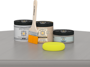 Retique It® Weathered Wood Multipurpose Kit contents with Liquid Wood primer, Weathered Wood gel stain alternative, PolyTique It® satin exterior top coat, paintbrush, and yellow sponge displayed on a gray wood surface.