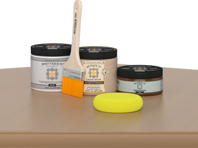 Retique It® Pecan Multipurpose Kit contents with Light Wood Liquid Wood primer, Pecan gel stain alternative, PolyTique It® satin exterior top coat, paintbrush, and yellow sponge displayed on a wood surface.
