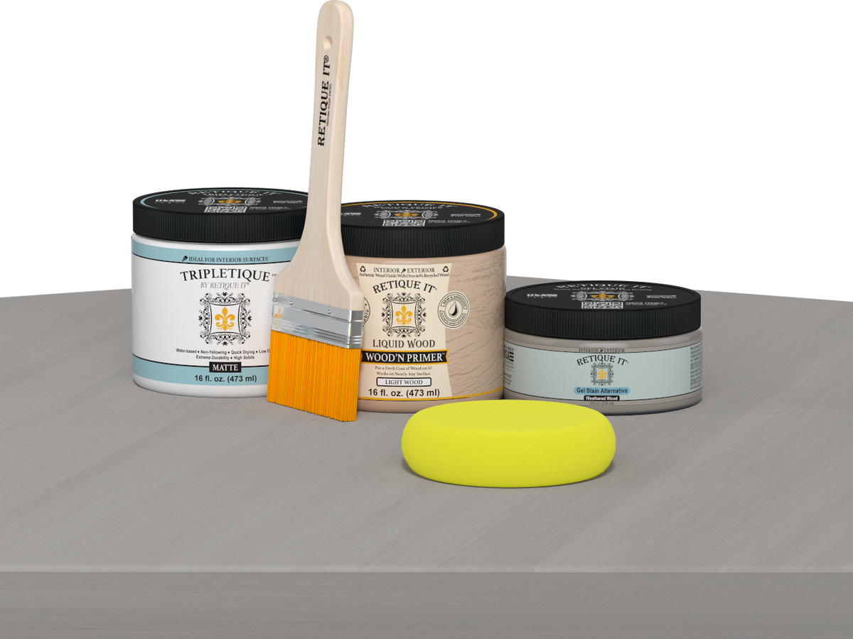 Retique It® Weathered Wood Multipurpose Kit contents with Light Wood Liquid Wood primer, Weathered Wood gel stain alternative, Tripletique matte interior top coat, paintbrush, and yellow sponge displayed on a gray wood surface.