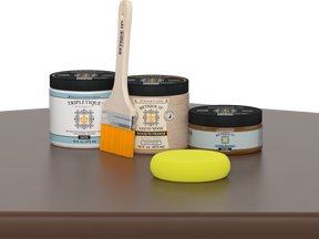 Retique It® Dark Oak Multipurpose Kit contents with Liquid Wood primer, Dark Oak gel stain alternative, Tripletique satin interior top coat, paintbrush, and yellow sponge displayed on a dark wood surface.