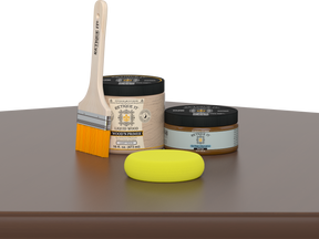 Retique It® Dark Oak Multipurpose Kit contents with Liquid Wood primer, Dark Oak gel stain alternative, paintbrush, and yellow sponge displayed on a dark wood surface.