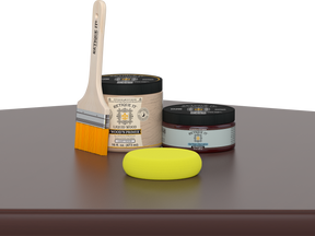 Retique It® Red Mahogany Multipurpose Kit contents with Liquid Wood primer, Red Mahogany gel stain alternative, paintbrush, and yellow sponge displayed on a dark wood surface.