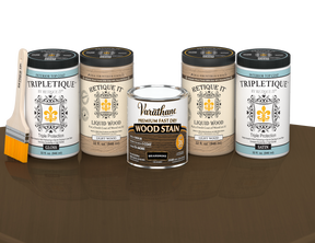 64 oz Retique It Liquid Wood kit with Briarsmoke stain, gloss Tripletique topcoat, and a paintbrush on a matching finished tabletop.