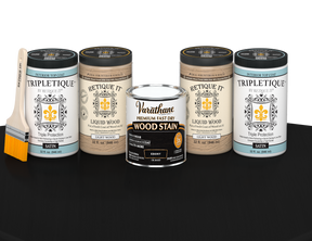 64 oz Retique It Liquid Wood kit with Ebony stain, satin Tripletique topcoat, and a paintbrush on a matching finished tabletop.