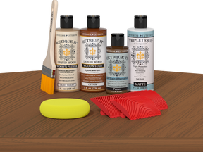 Retique It® Wood'n Finish Kit in Cedar stain displayed on a tabletop, showcasing natural wood finish and stain application.