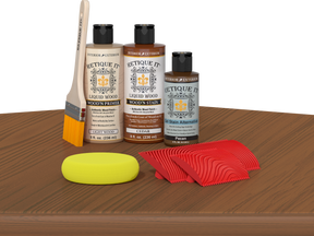 Retique It® Wood'n Kit cedar finish, multi-purpose wood finishing kit shown on table with applicator tools and wood sample.