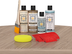 Retique It® Wood'n Finish Kit in French Oak for interior top coat, shown on table with wood sample and application tools.