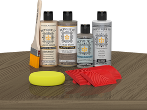 Retique It® Wood'n Kit in Weathered Wood finish, featuring exterior top coat and wood finish supplies on a table.