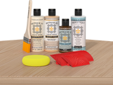 Retique It® Wood'n Finish Kit in White Oak stain displayed on a table, showcasing the stain's color and application on wood surface.