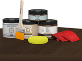 Retique It® Wood'n Finish Kit in Black Walnut for exterior wood projects, featuring a top coat and application tools on a table.