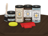 Retique It® Wood'n Finish Kit in black walnut stain, featuring four large stain bottles with a matte finish on a wooden table.