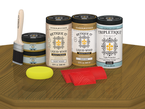Retique It® Wood'n Finish Kit in Old Oak stain, featuring four large stain bottles with a glossy finish on a wooden surface.