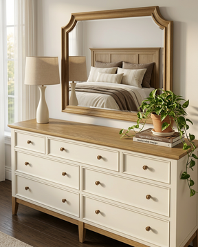 Wooden dresser with mirror and decorative items in a bedroom setting